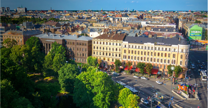 Aerial view of central Riga with Opera Hotel & Spa and surrounding buildings on a sunny day.